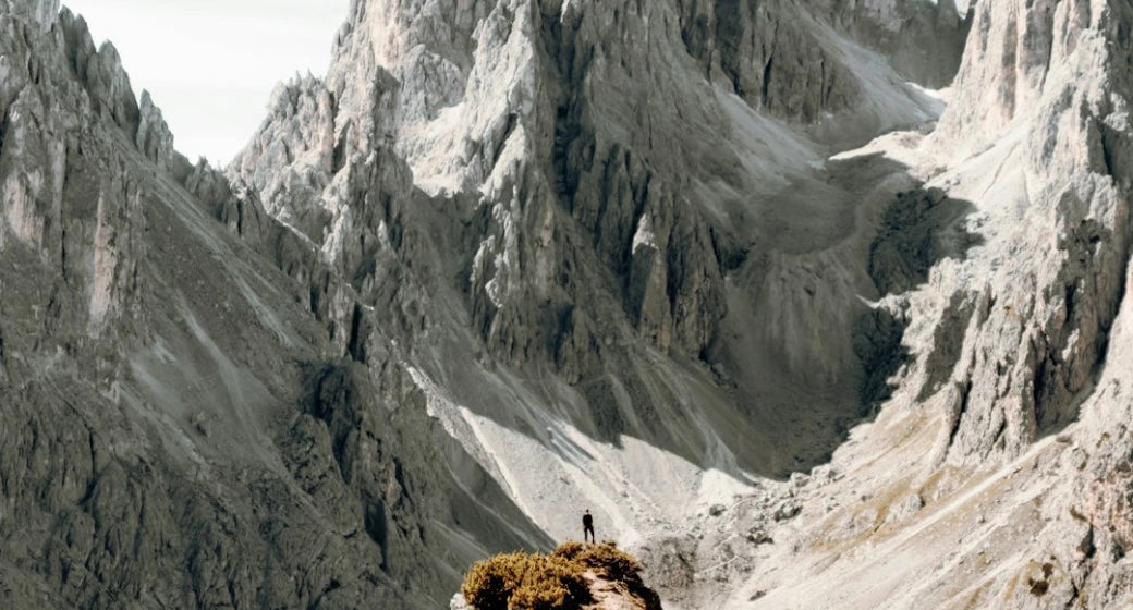 Photographer working in a dramatic mountain landscape
